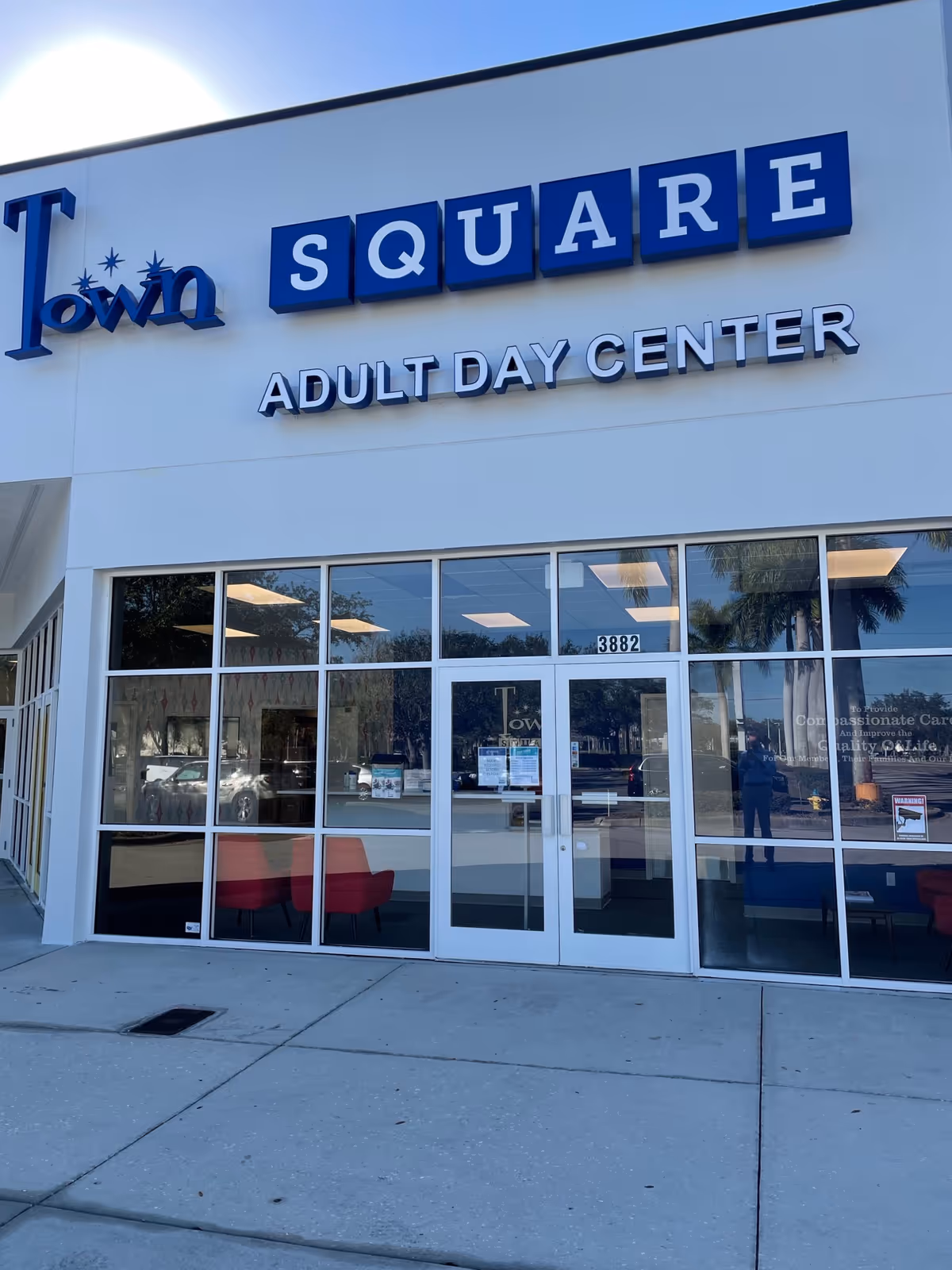 Exterior storefront of Town Square Adult Day Center with blue block-letter signage.