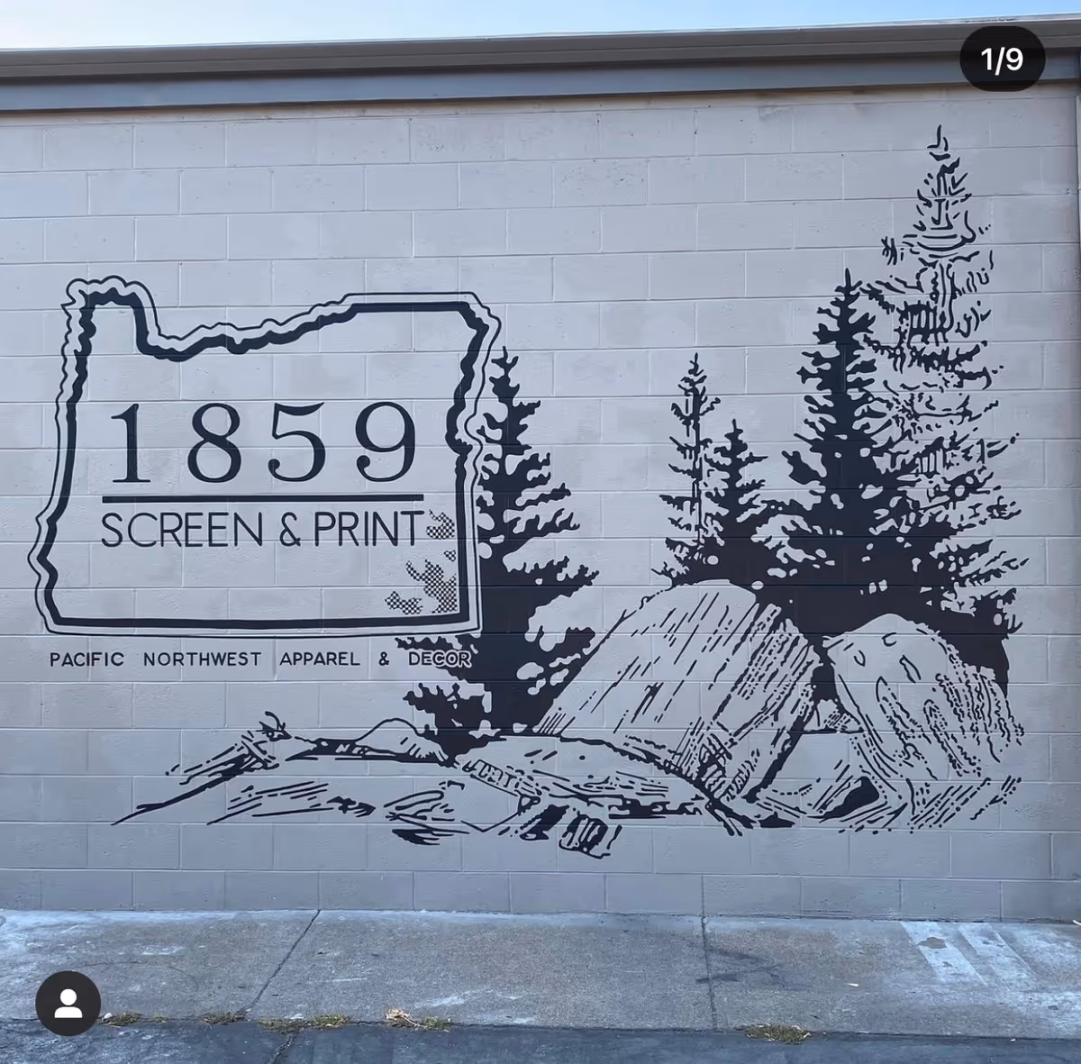 Gray exterior wall mural featuring trees, rocks, and the text 1859 Screen & Print.