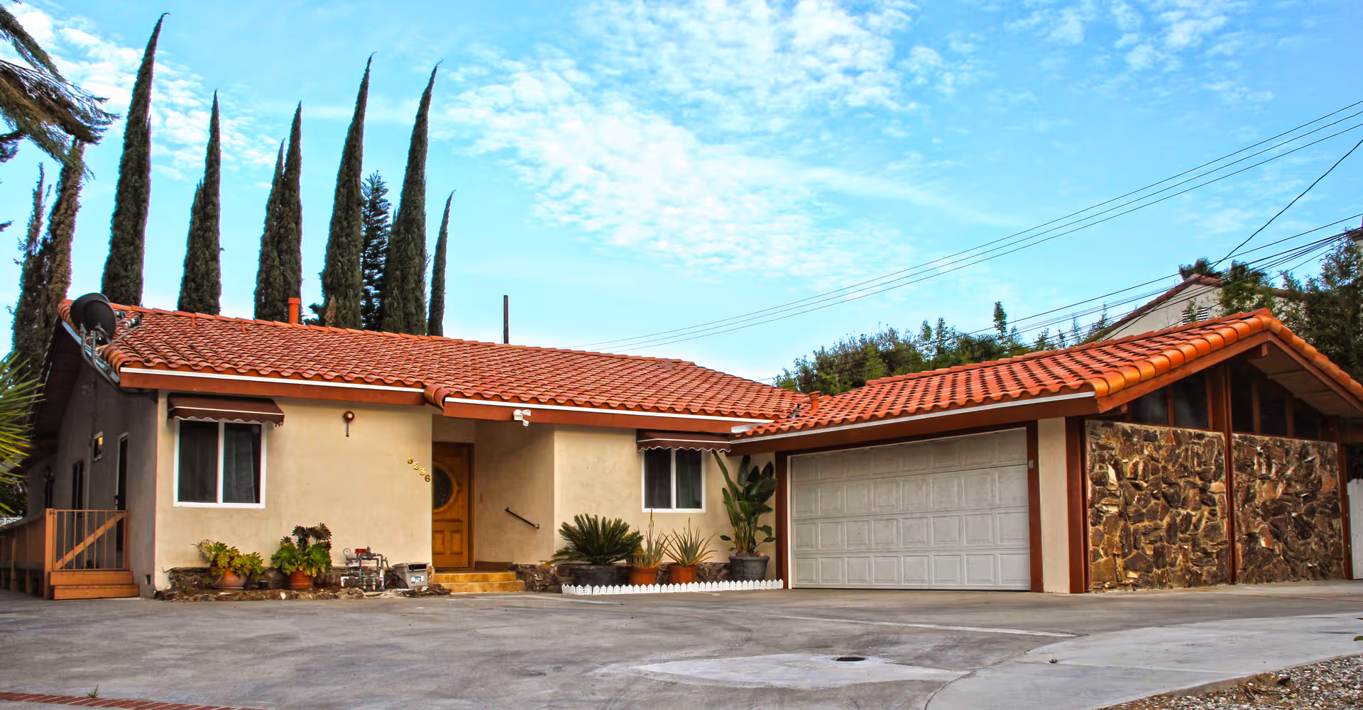 Exterior view of Van Nuys Senior Living, Inc., a single-story building with a two-car garage.