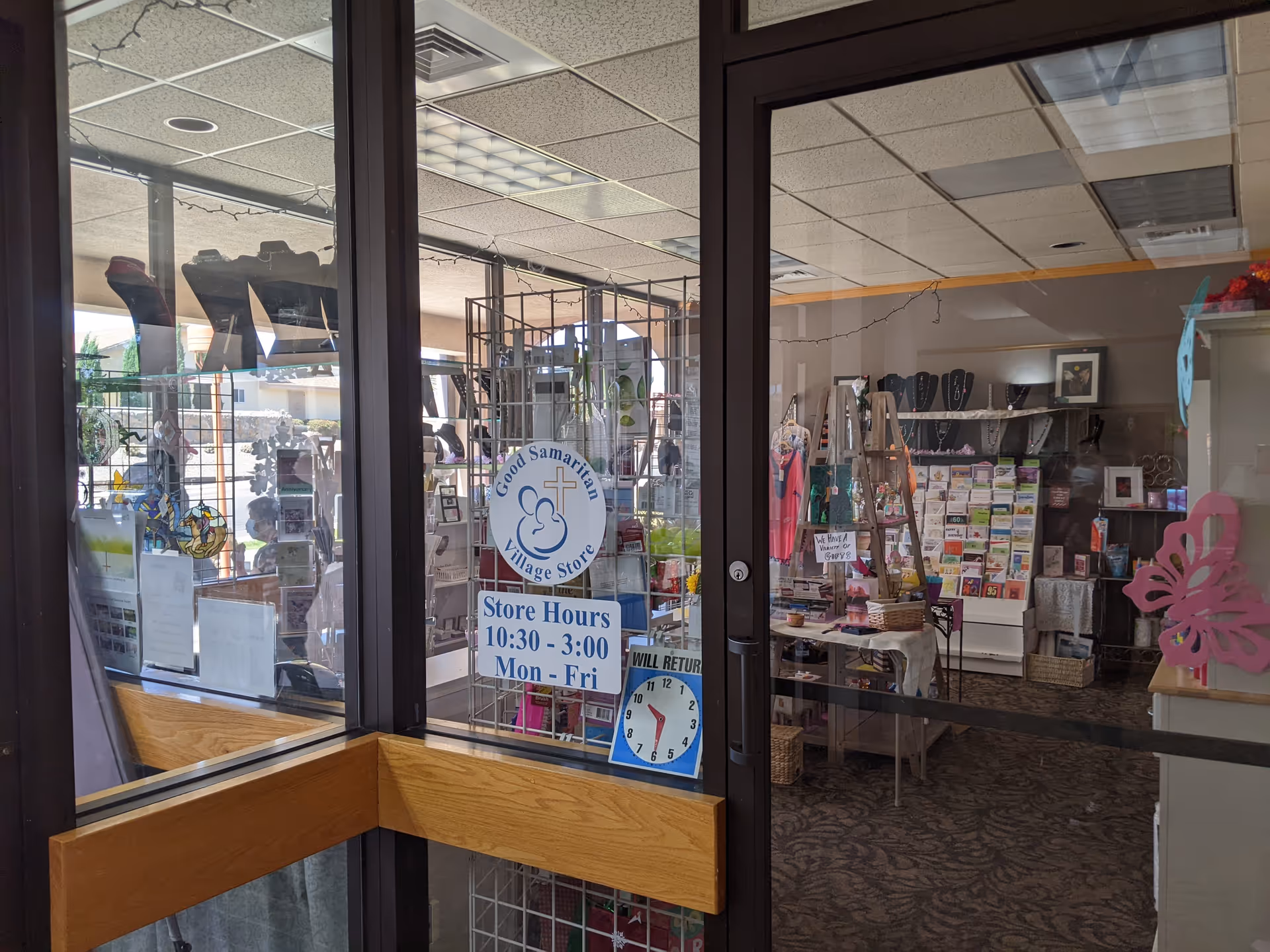 Interior view of a senior living store seen through glass doors with merchandise.