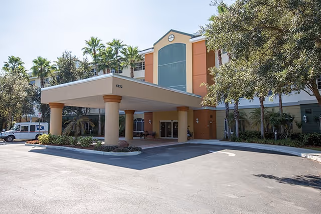 Front view of Discovery Village at Boynton Beach entrance with covered drop-off canopy.