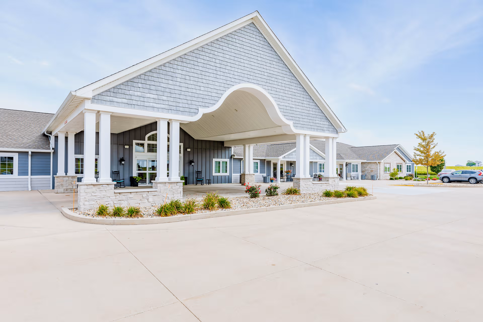 Exterior of Villas of Holly Brook senior living facility with covered entry.