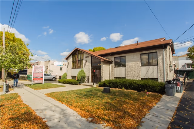 Front exterior of Richmond Physical Therapy clinic with sign, shrubs, and sidewalk.
