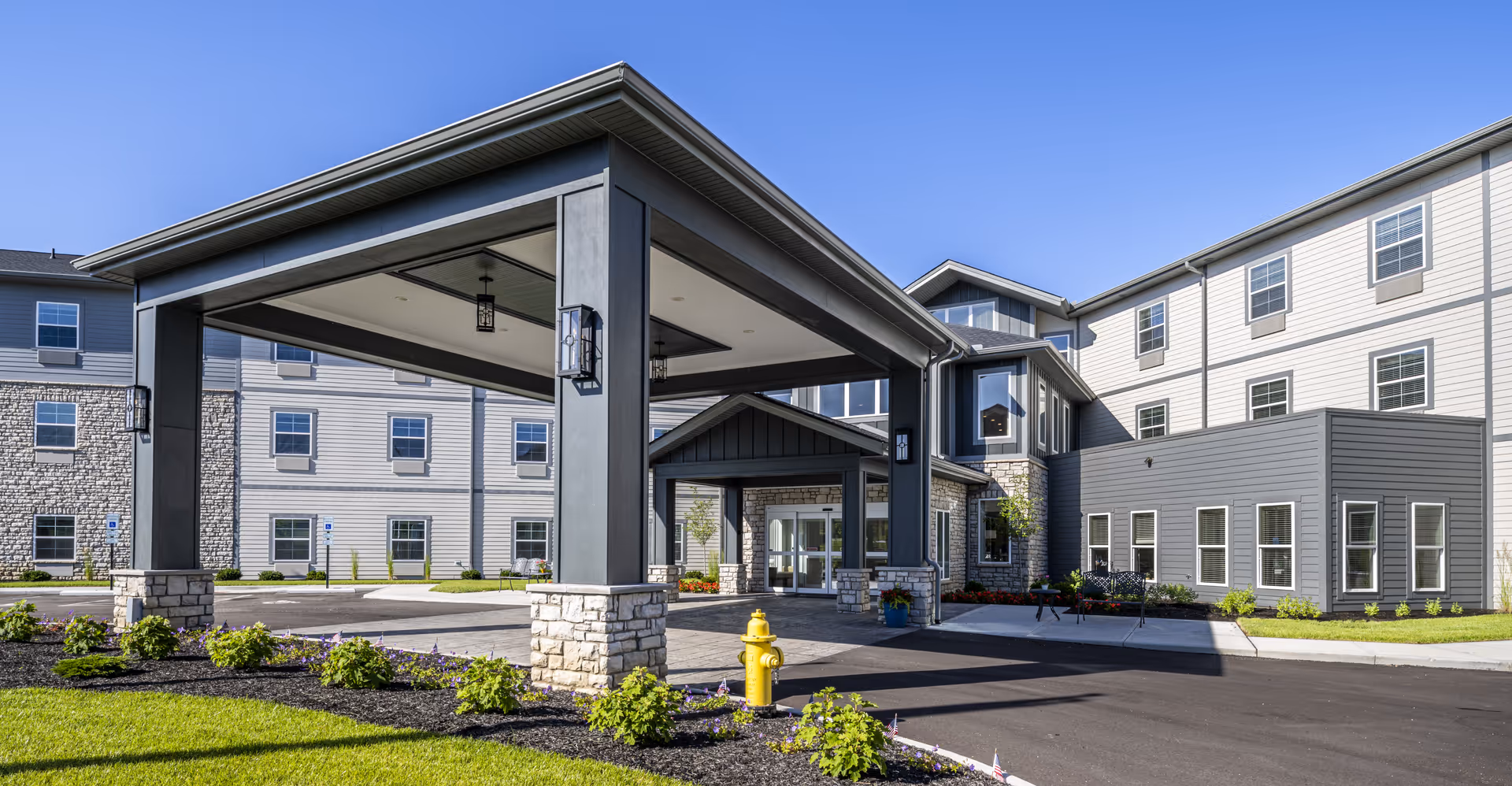 Exterior view of Provision Living at West Chester, showing the covered entrance and modern multi-story building.