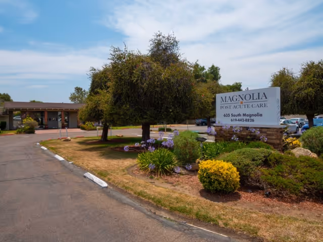 Driveway and landscaped entrance with a prominent sign for Magnolia Post Acute Care.