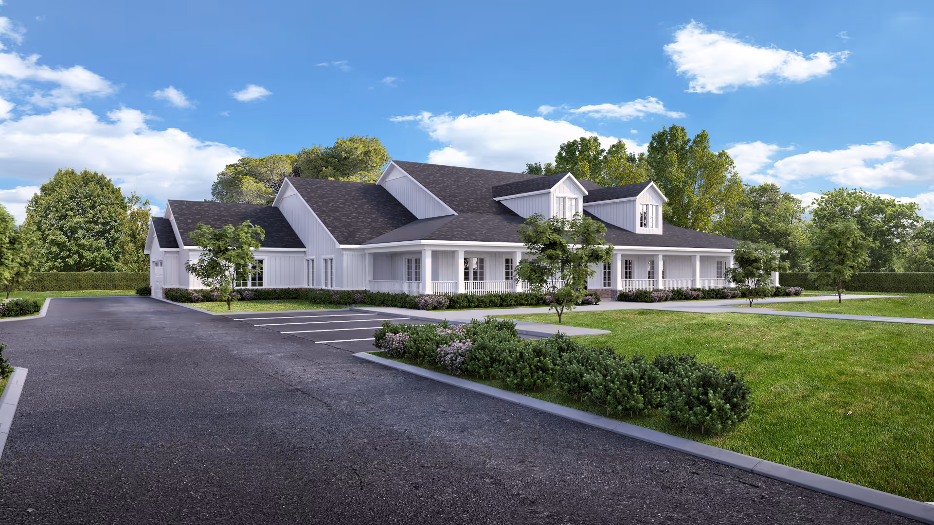 White, gabled senior living campus with manicured lawn, trees, and a paved parking area.