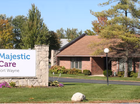 Exterior view of Majestic Care Fort Wayne with brick building and sign.