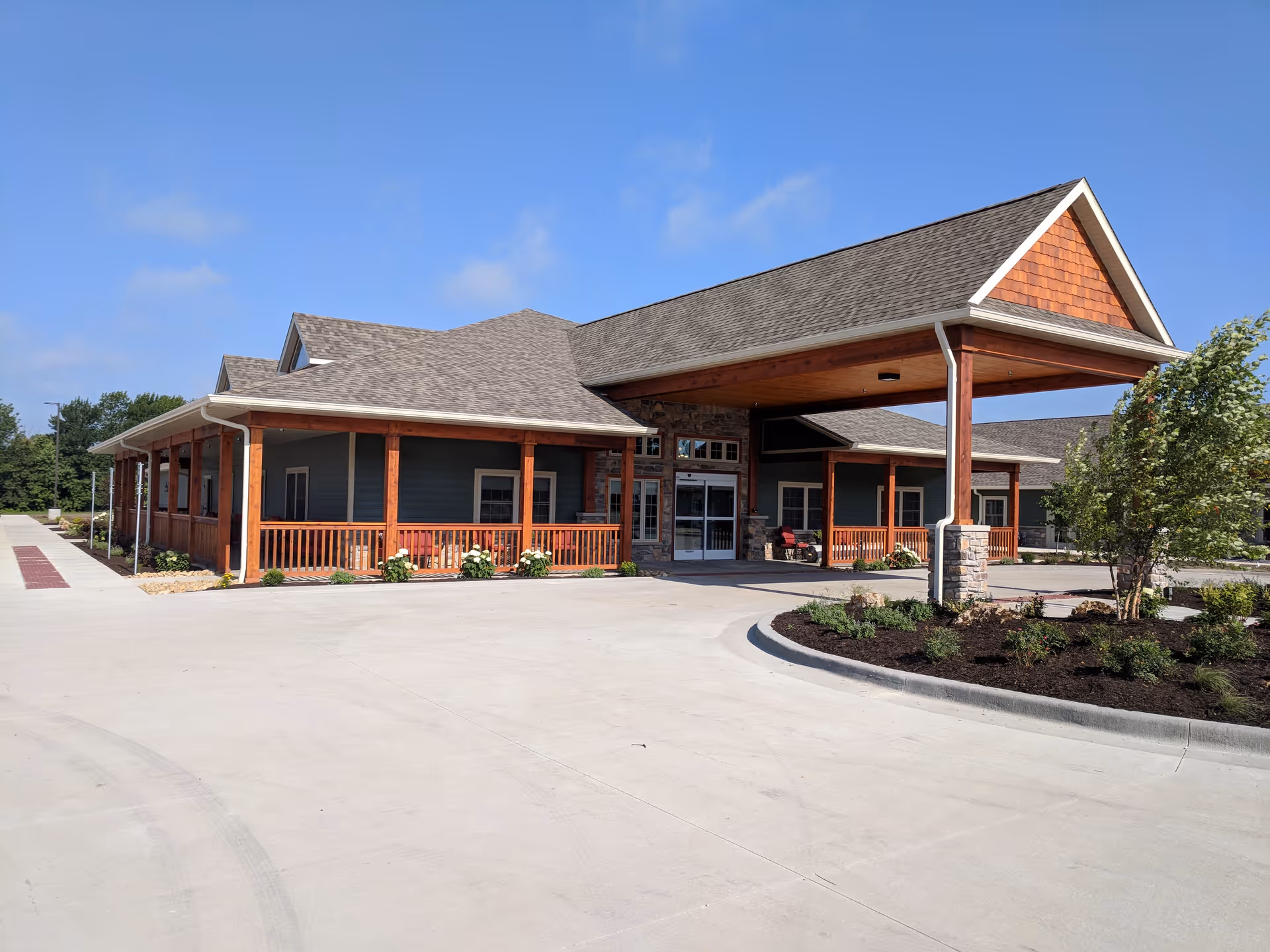 Exterior view of Timber Creek Village Assisted Living entrance with covered porte-cochère