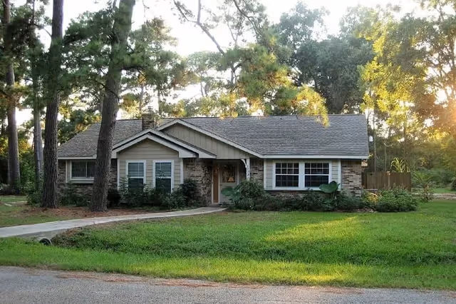 Exterior view of a single-story Avista Living facility with lawn and trees.