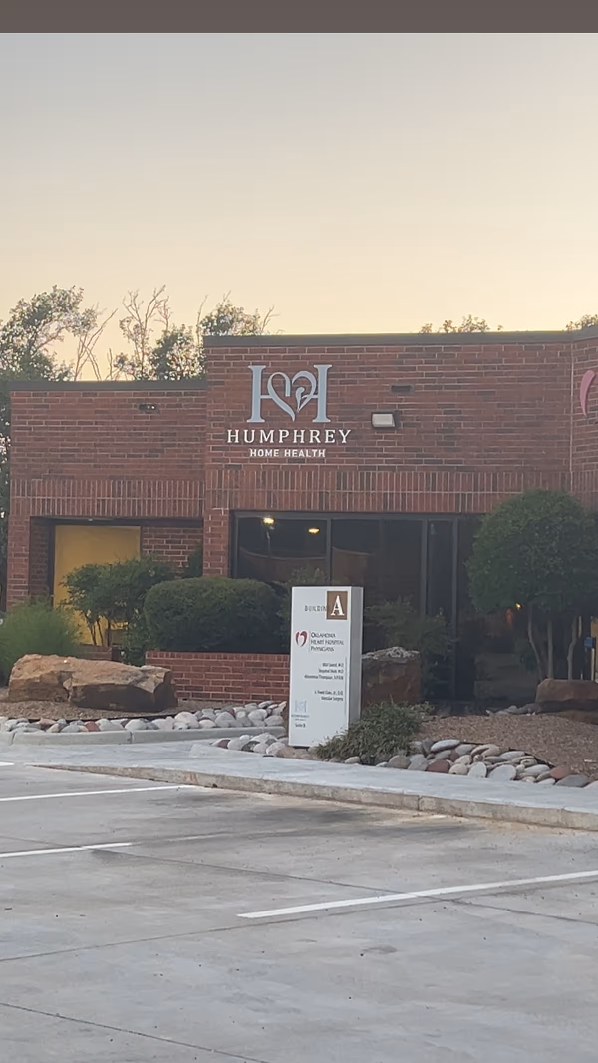 Exterior view of a brick Humphrey Home Health building with signage and landscaped entrance.