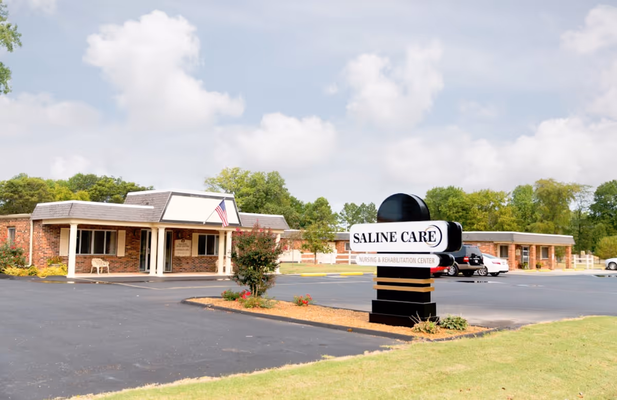 Exterior view of Saline Care Nursing and Rehab facility with parking and sign.