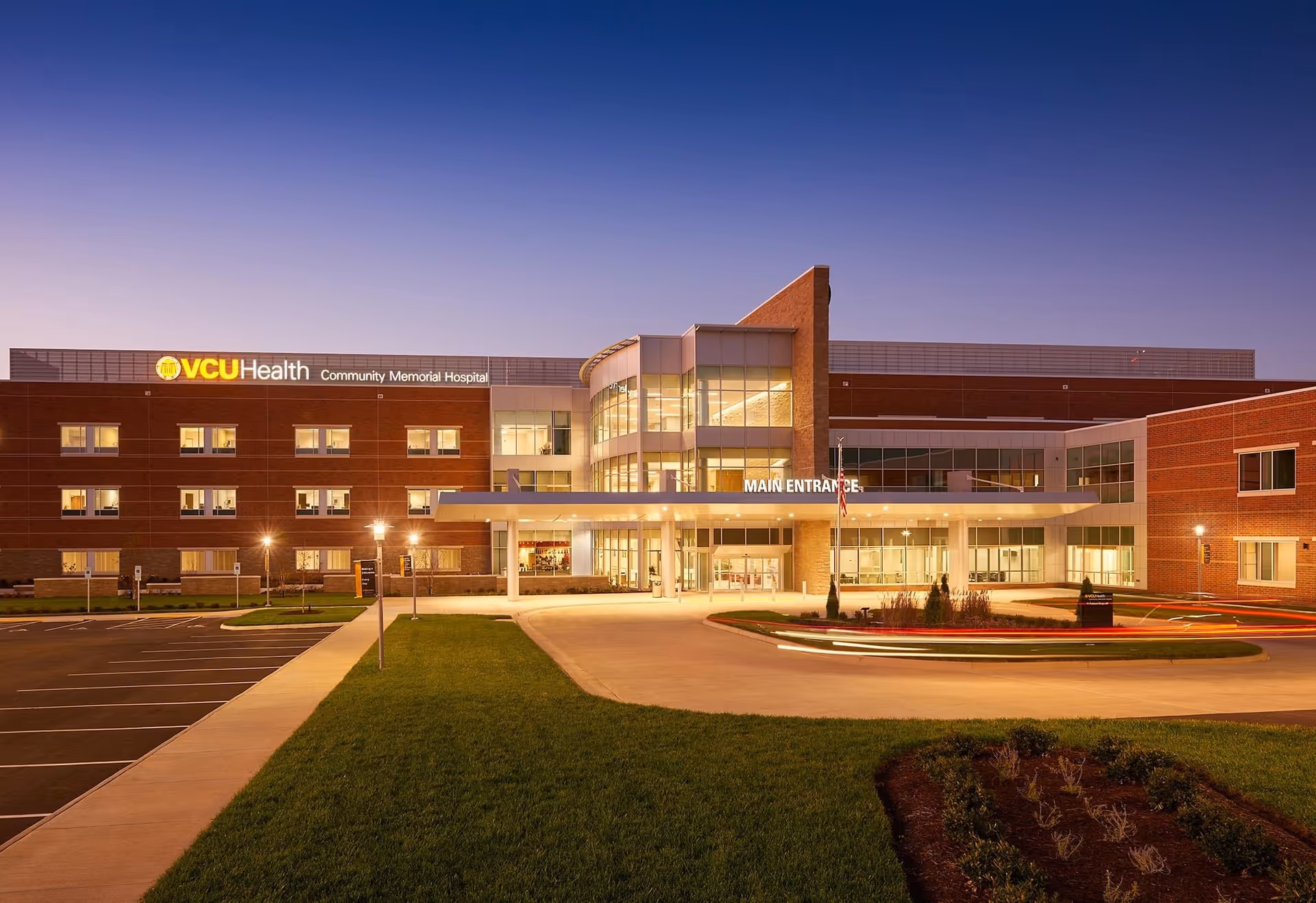 VCU Health Community Memorial Hospital front exterior with glass main entrance and parking.