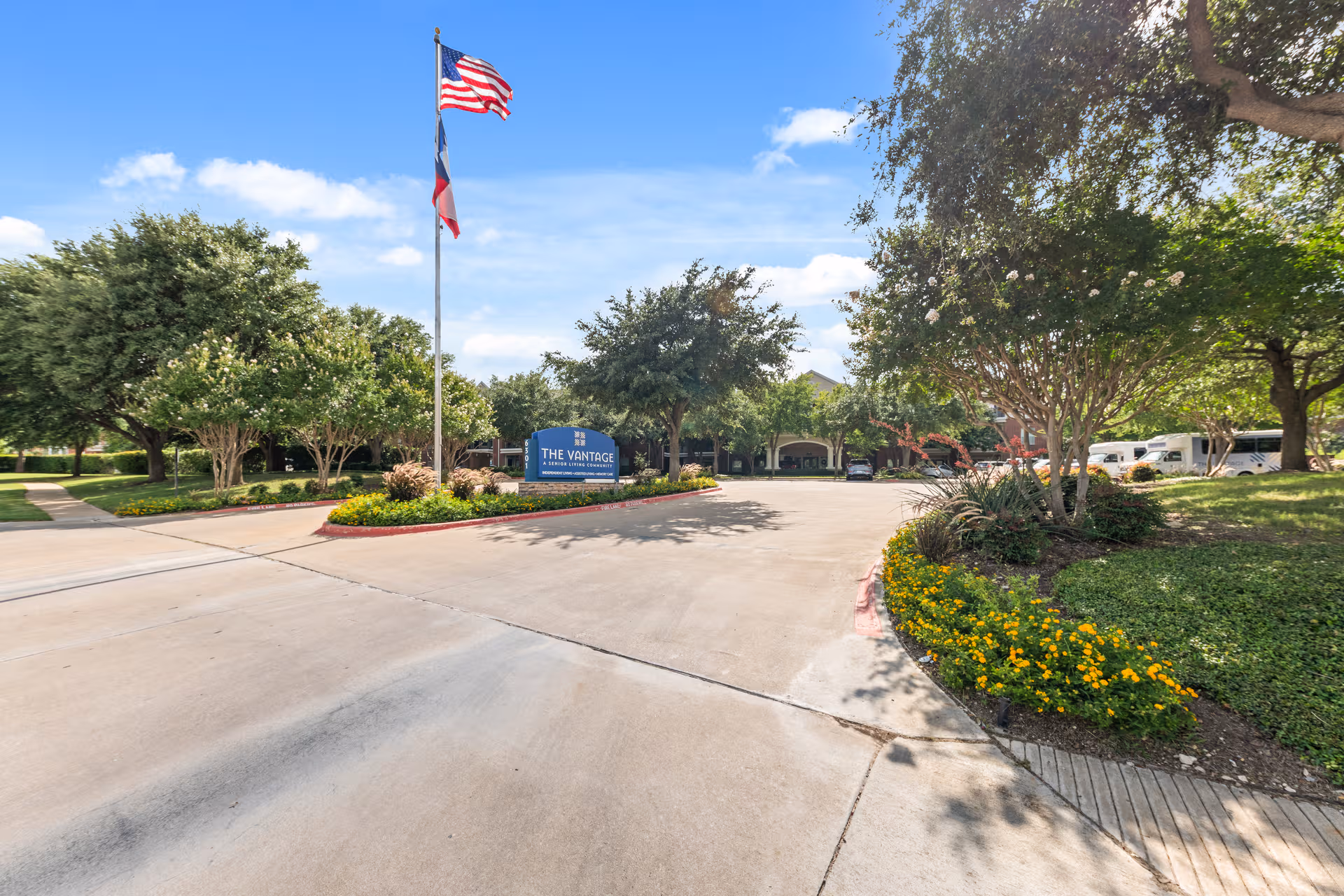 Exterior view of The Vantage at Cityview with entrance, flagpole, and landscaping.
