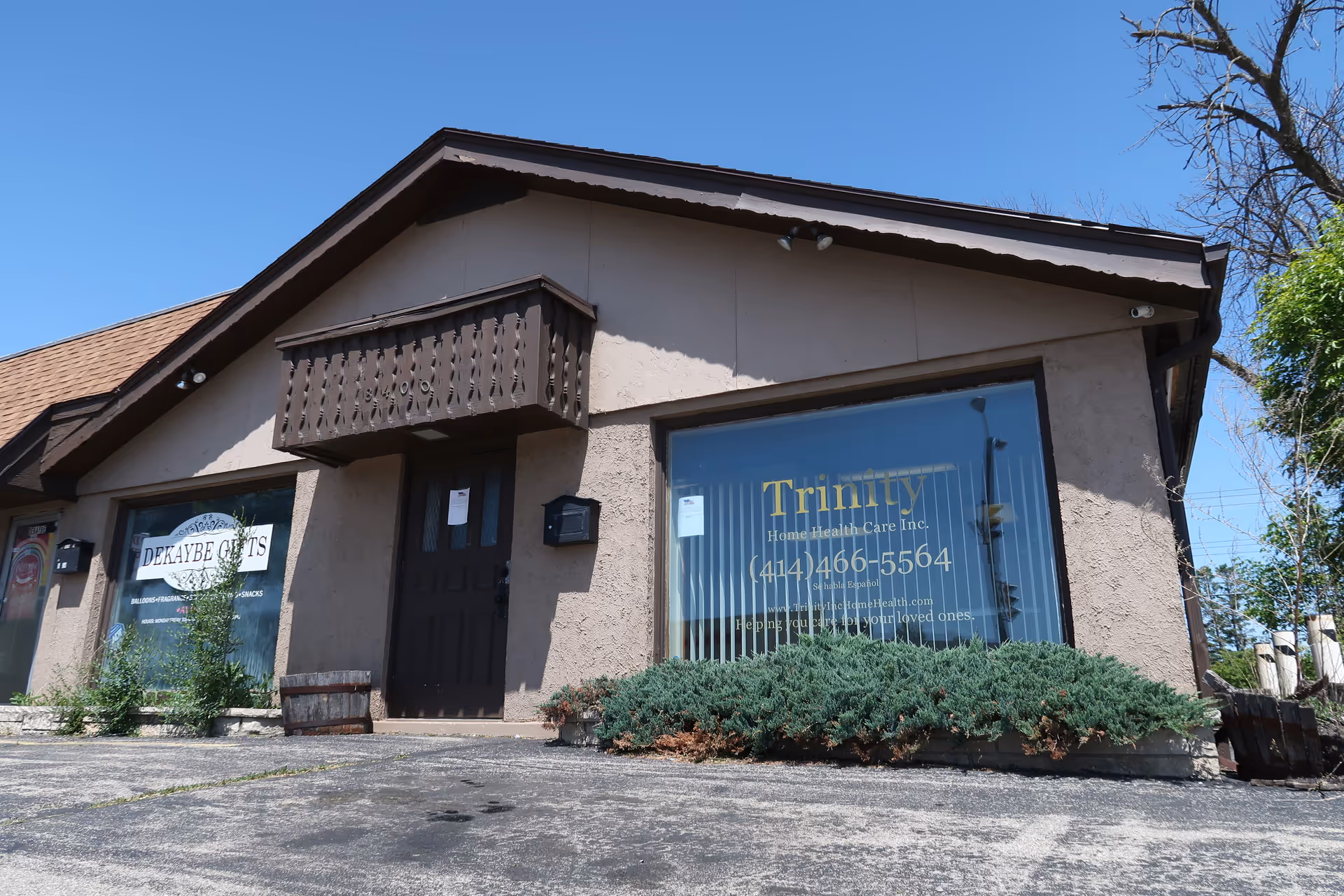 Exterior of Trinity Home Health Care, Inc. building with large front window and shrubs.