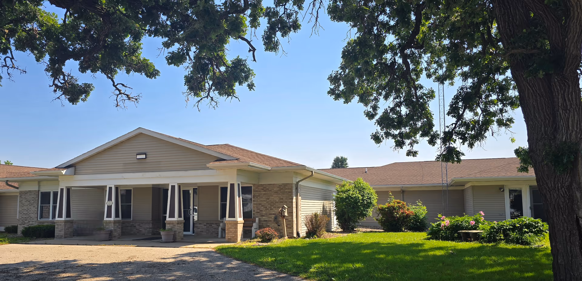 Single-story senior living facility with a covered front entrance and green lawn