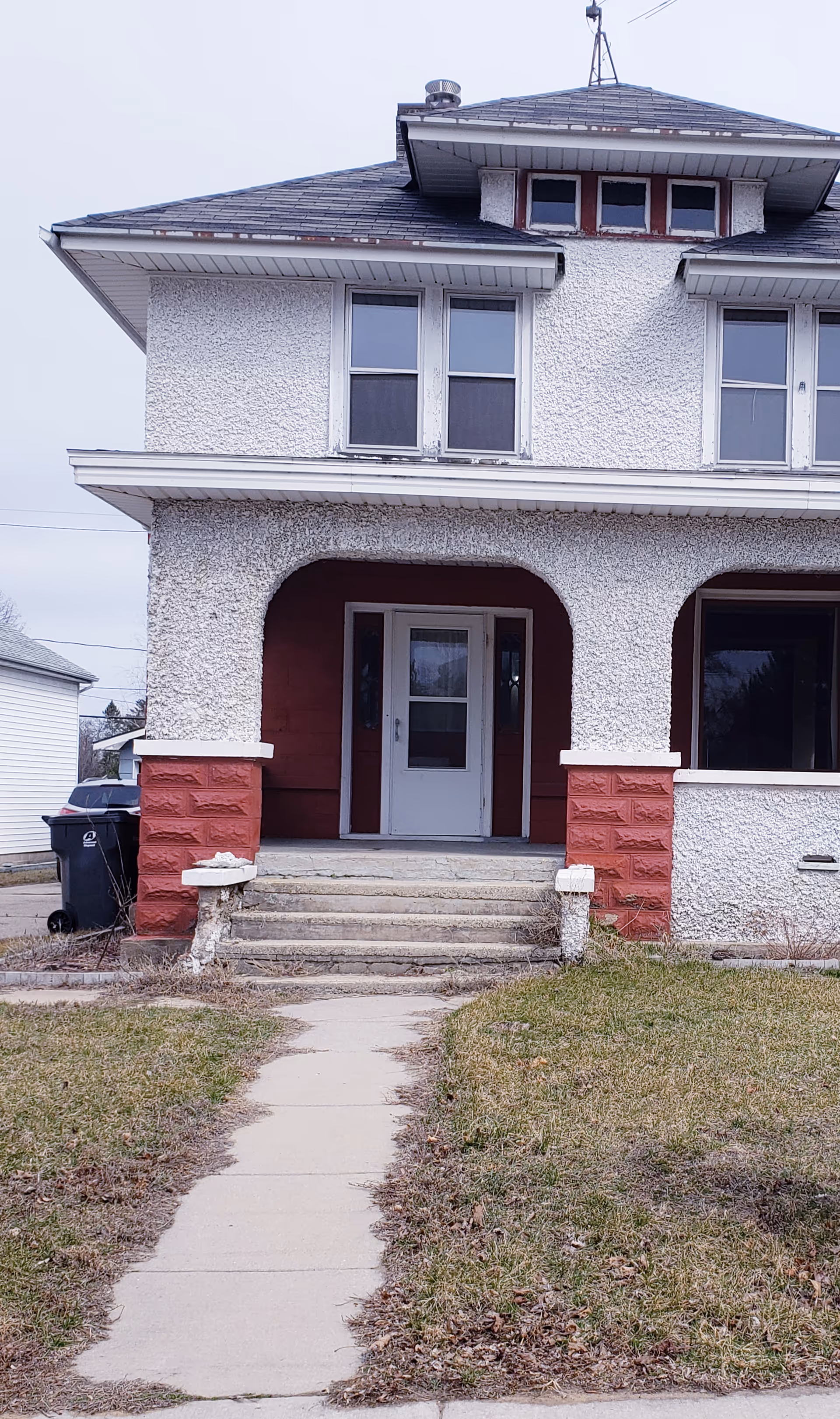 Front view of Tenderheart Adult Family Home, a two-story building with arched entrance.