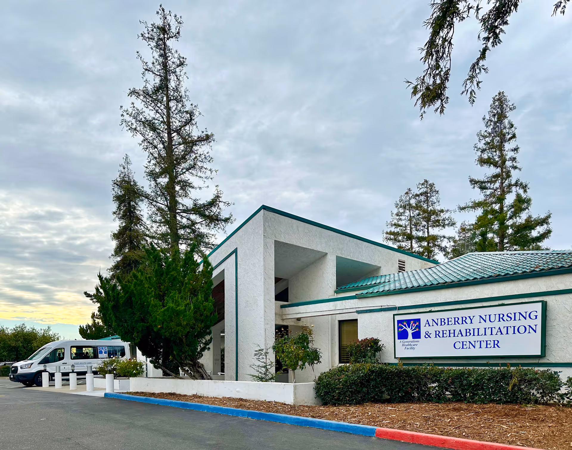 Exterior view of Anberry Nursing and Rehabilitation Center with entrance and sign