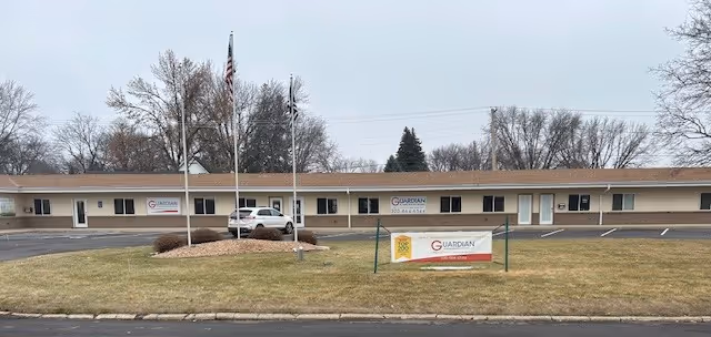 Single-story Guardian facility building with lawn, parking lot, and front signage.