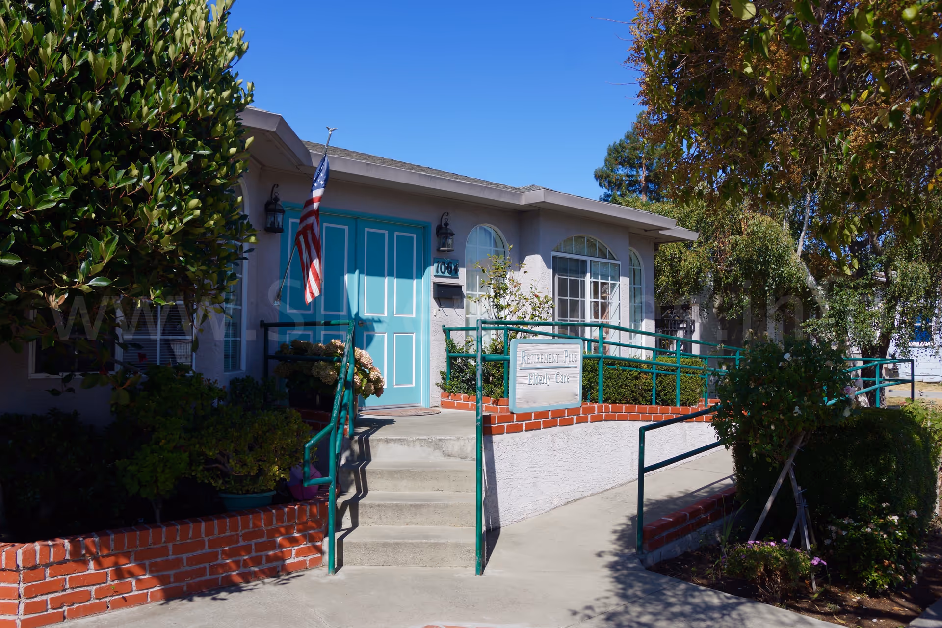 Front exterior of Peninsula Elderly Care Home-Laurel with turquoise door and ramp.