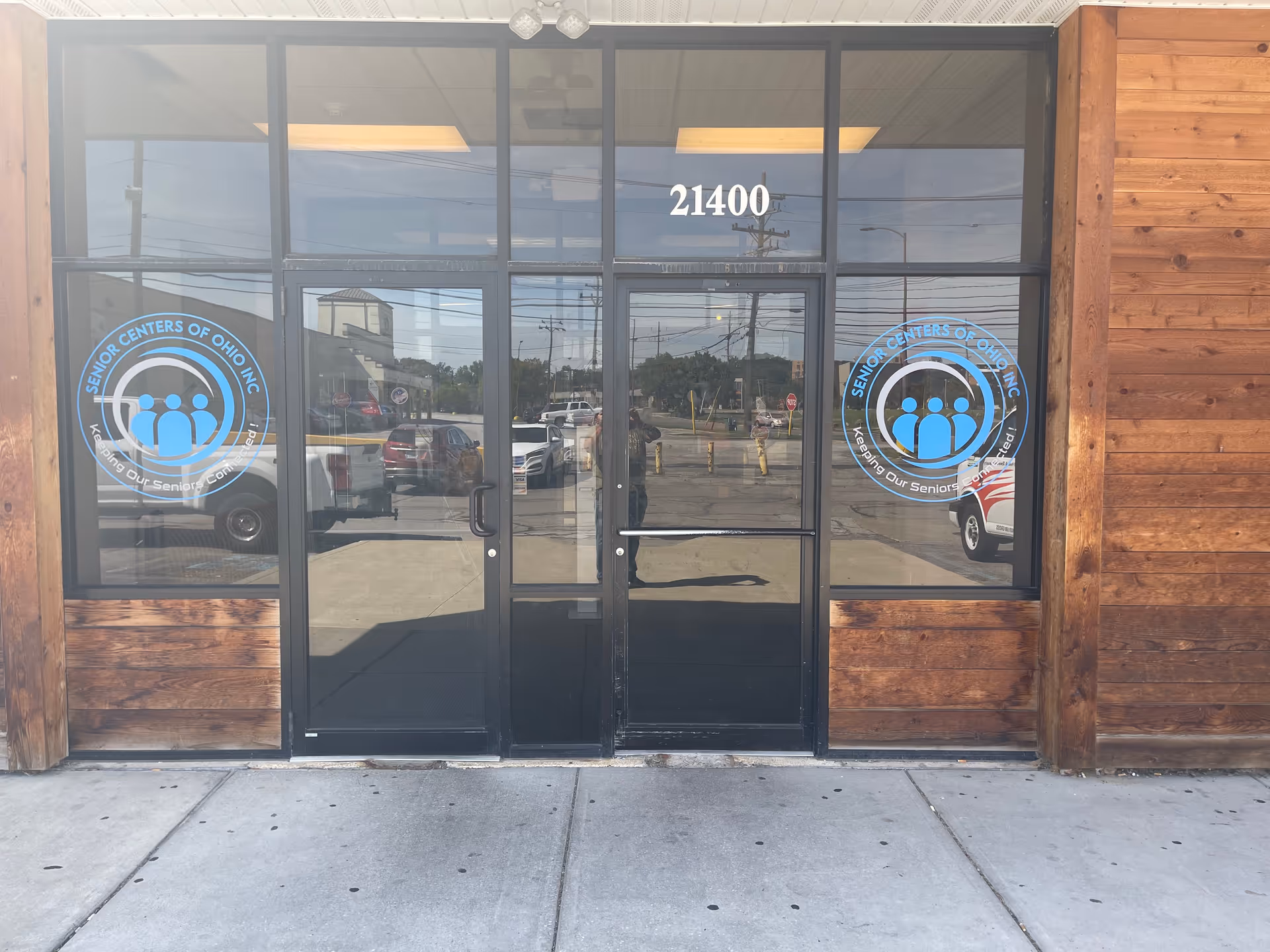 Glass front entrance of Senior Centers of Ohio Inc building with circular logos.