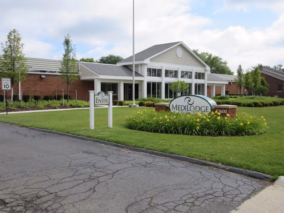 Exterior view of Medilodge of Taylor with the entrance, sign, and landscaping.