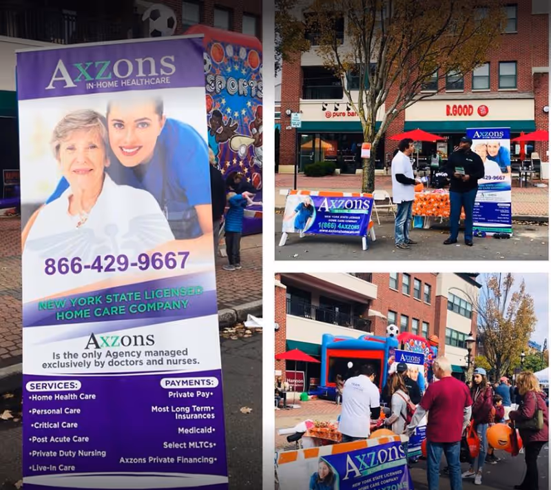 Outdoor Axzons Homecare promotional event with banners, booths, and people.