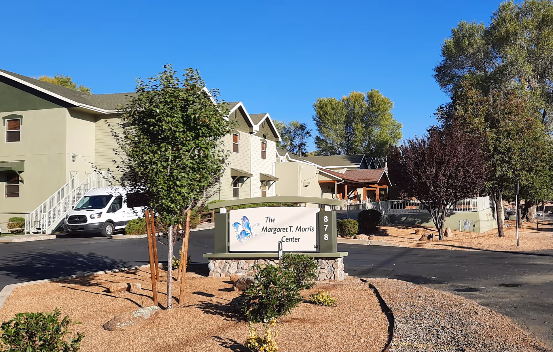 Exterior view of The Margaret T Morris Center with front sign and landscaped entrance.