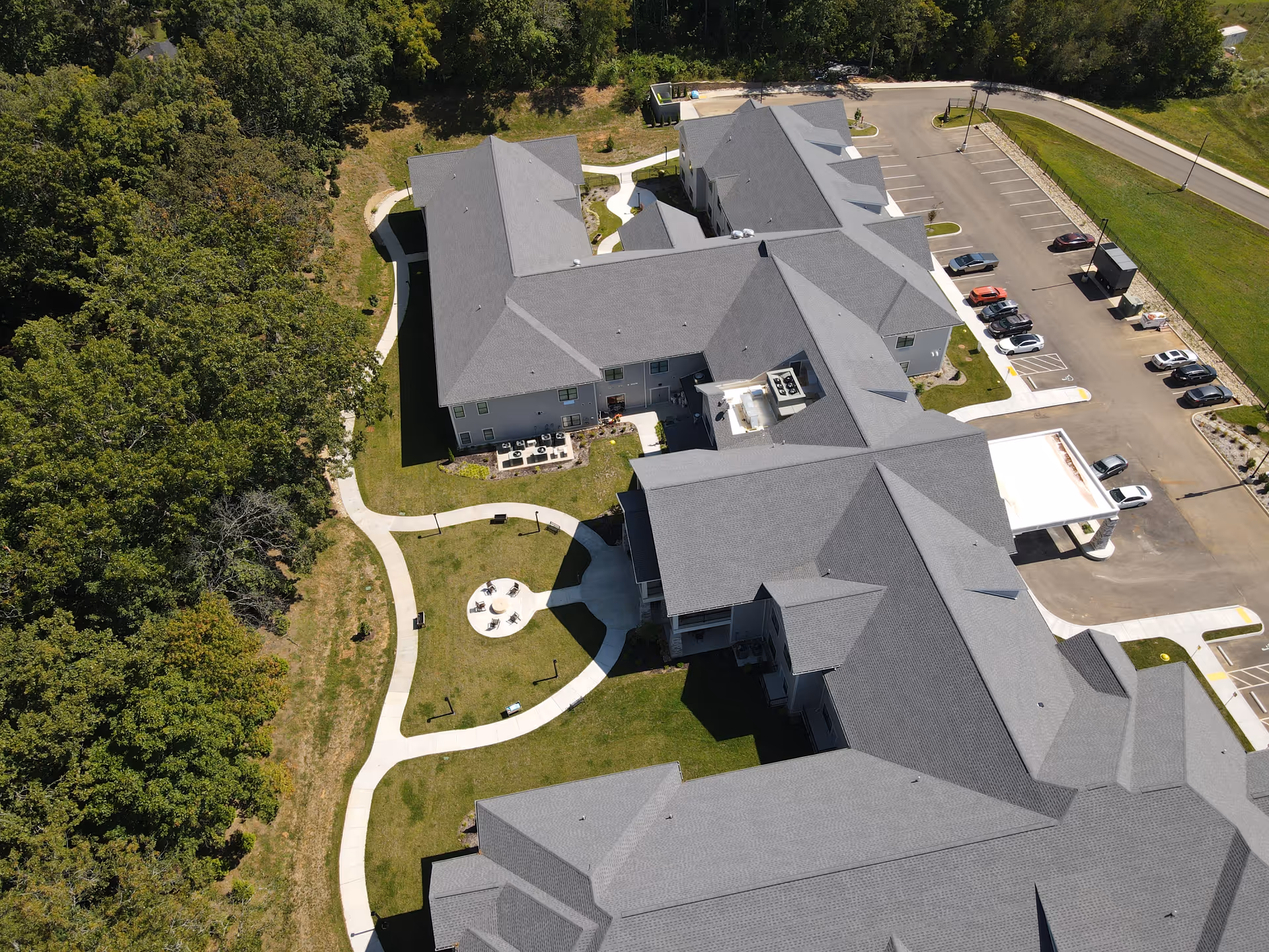 Aerial view of Emory Mills Senior Living campus showing grey rooftops and surrounding trees.