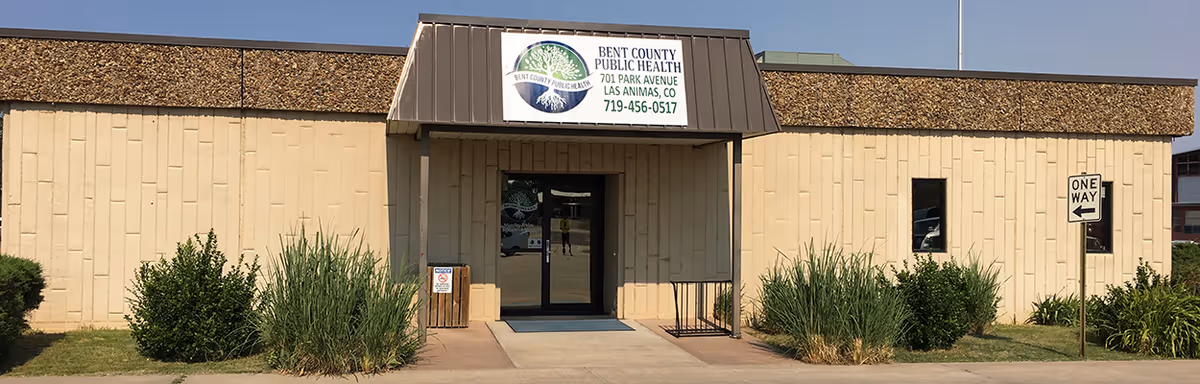 Front view of Bent County Public Health building with entrance and shrubs