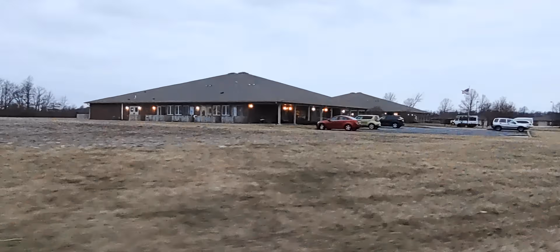 Exterior view of Crown Pointe of Hartford City, a single-story senior living facility with parking.