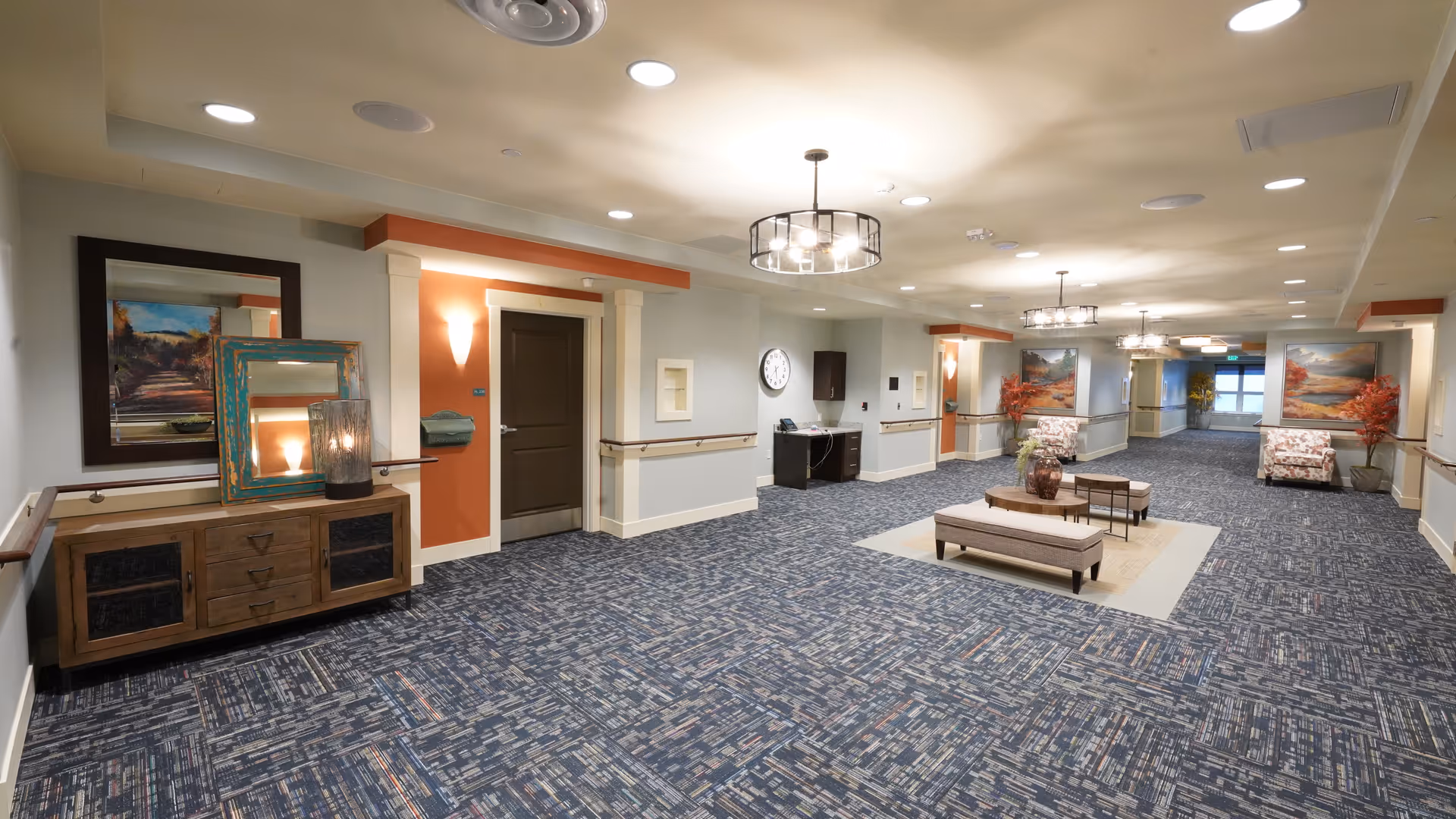 Spacious, well-lit interior of a senior living facility with seating and artwork.
