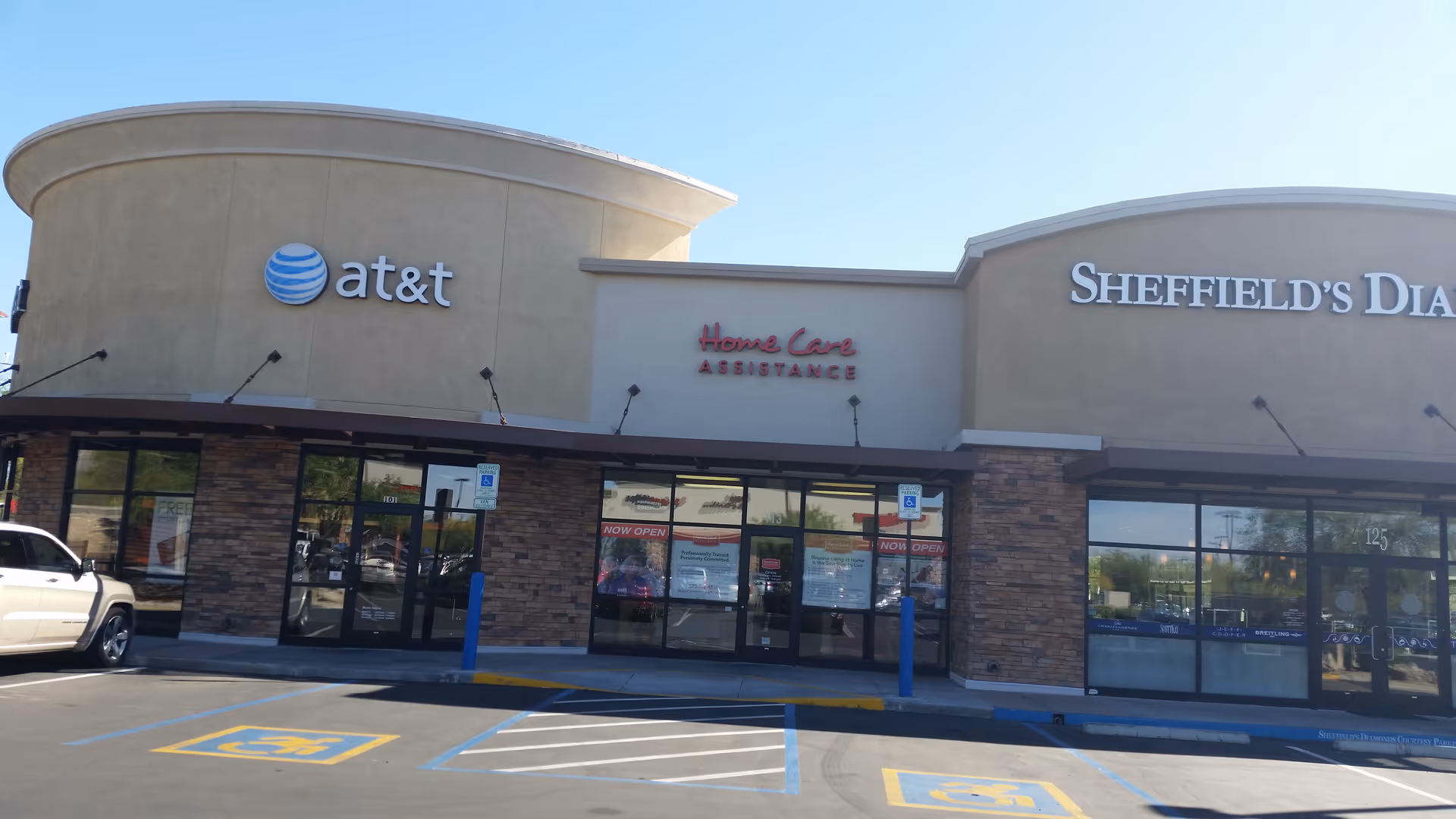 Exterior storefronts with Home Care Assistance Tucson sign and AT&T logo.