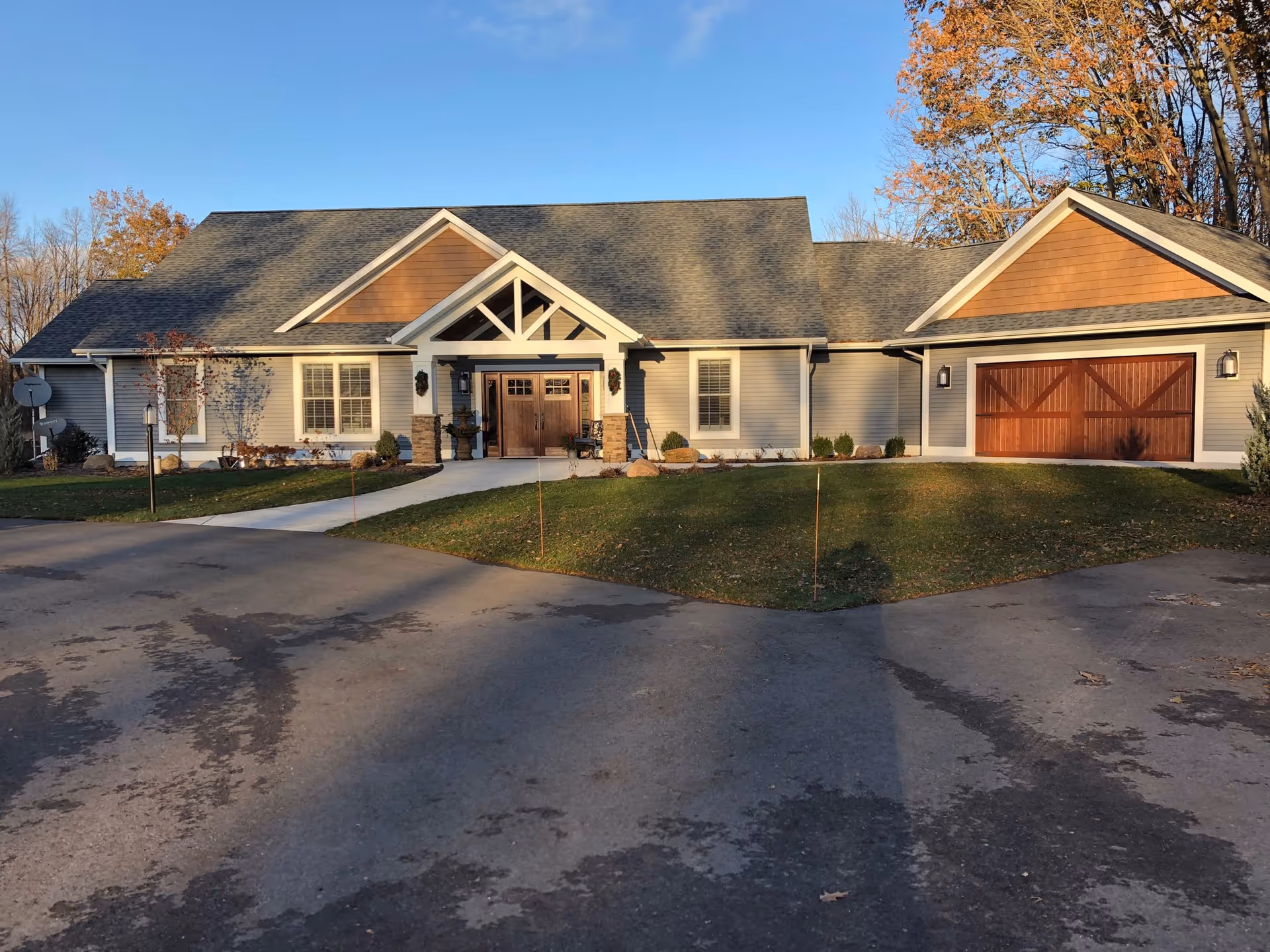 Front view of a single-story senior living facility with a front entrance and attached garage.