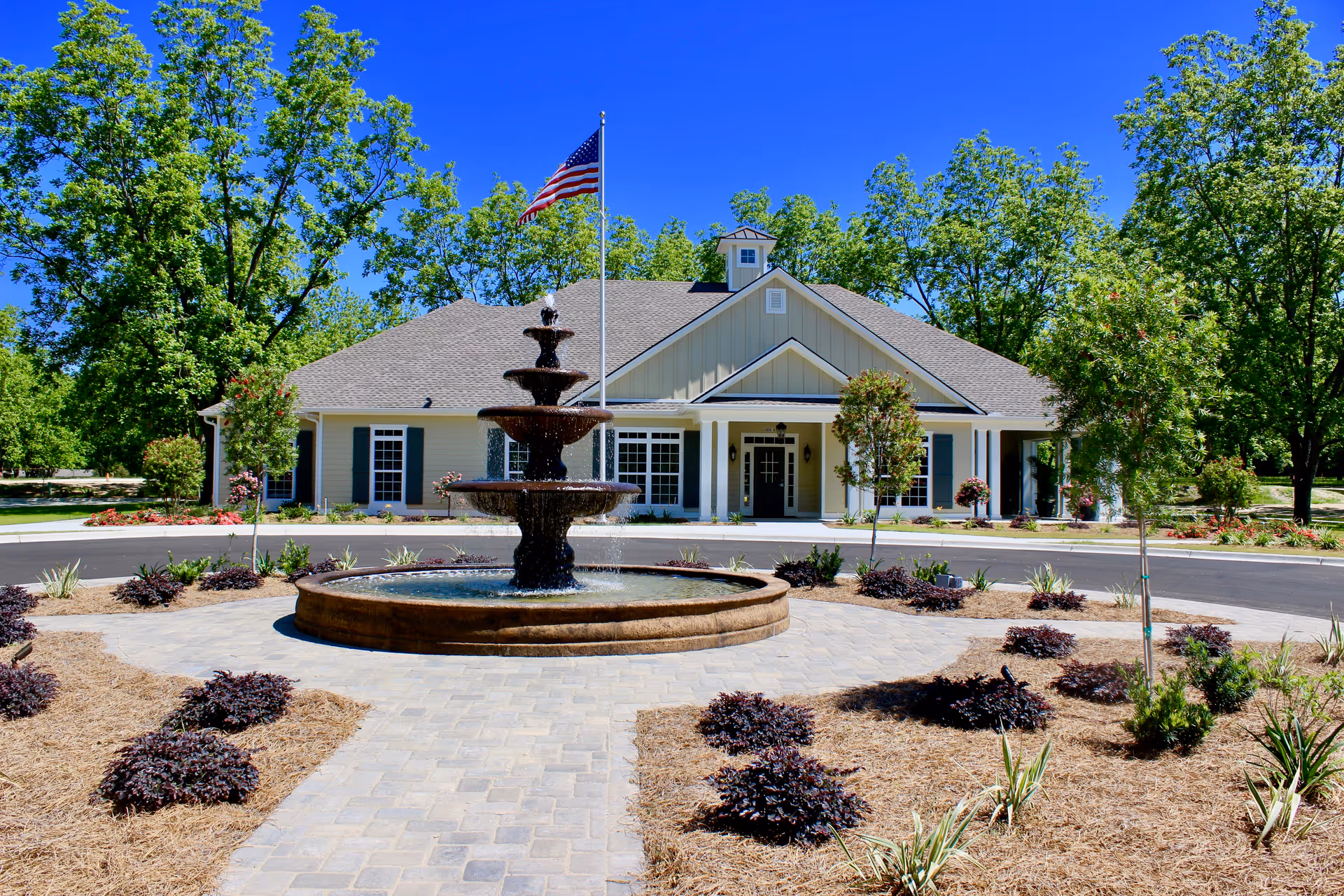 Front view of The Orchard at Stone Creek with a fountain and manicured landscaping.