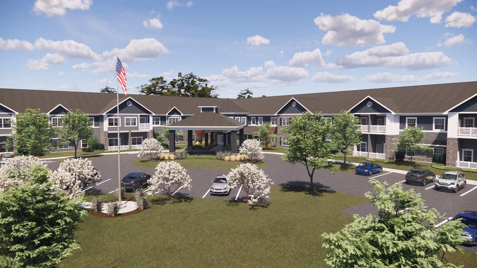 Exterior view of Danbury Mount Vernon senior living facility showing a two-story building with a covered entrance, surrounded by trees, parked cars, and a flagpole with an American flag under a partly cloudy sky.