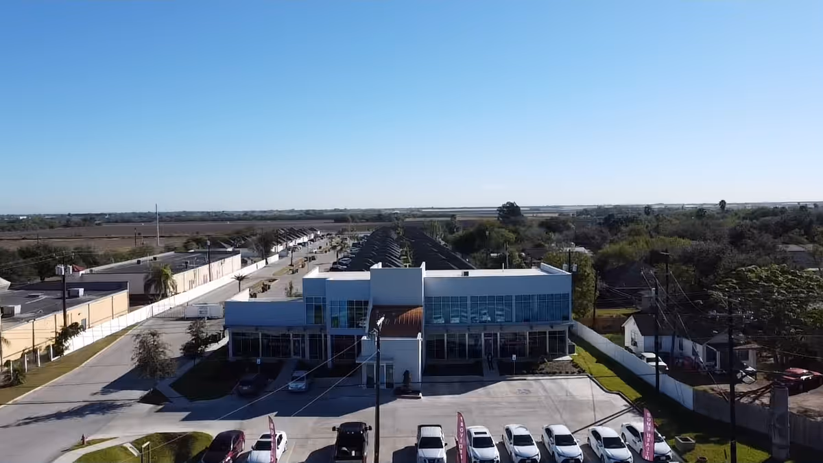 Aerial view of A Healing Touch Home Health, PAS & Hospice building with a parking lot.