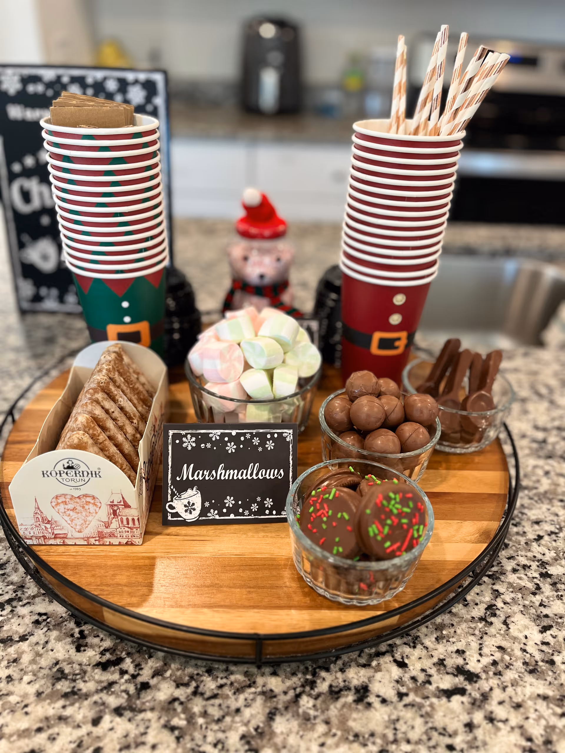 Festive holiday snack display on a kitchen counter with treats.