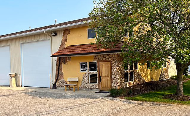 Exterior view of Anchor In-Home Care facility with stone facade and entry door.