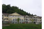 Exterior view of Vintage at Chehalis building with balconies and a green grassy lawn.