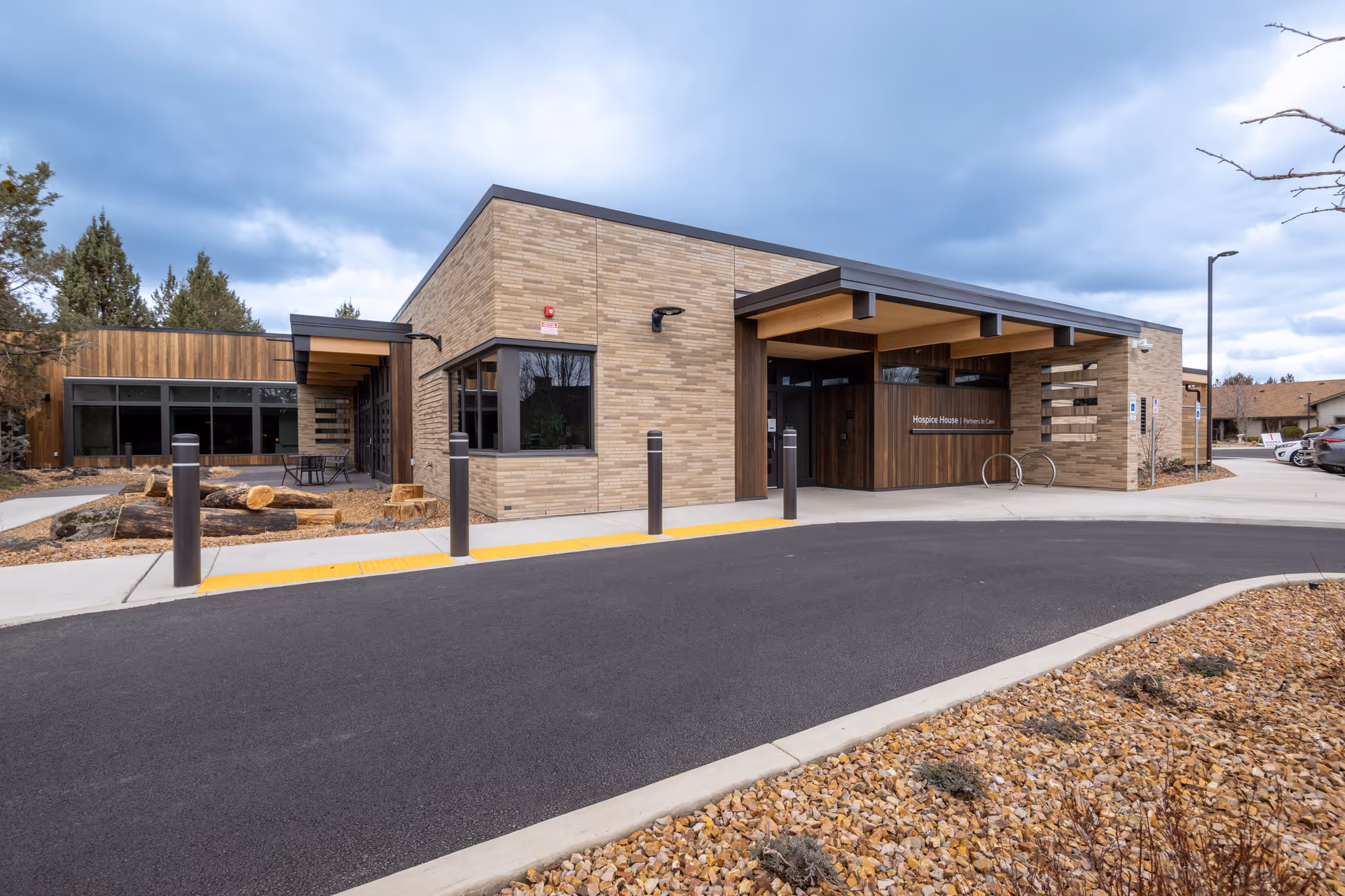 Exterior view of a brick senior living facility with a covered entrance.