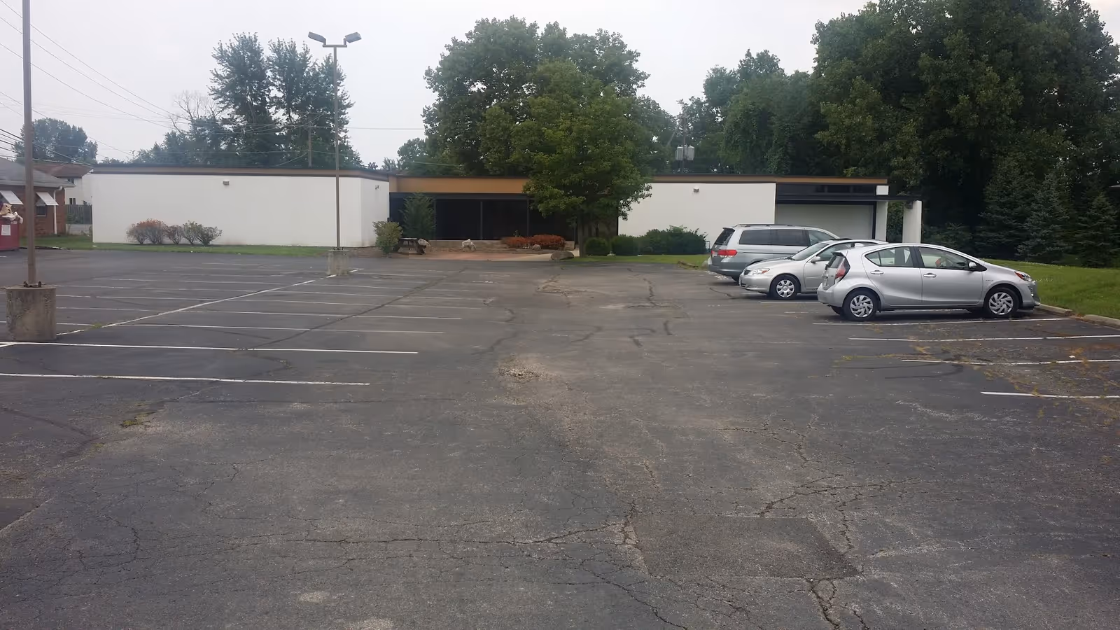 Exterior view of Nina's Health Care Services building with a parking lot and trees.