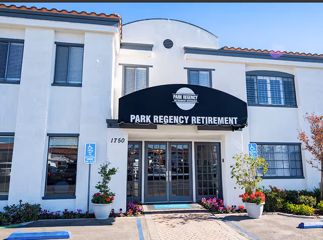 Front view of Park Regency Retirement Center entrance with a black awning and glass doors.