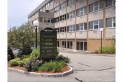 Exterior view of Sky View Rehabilitation & Health Care, brick building with sign and landscaped entrance.