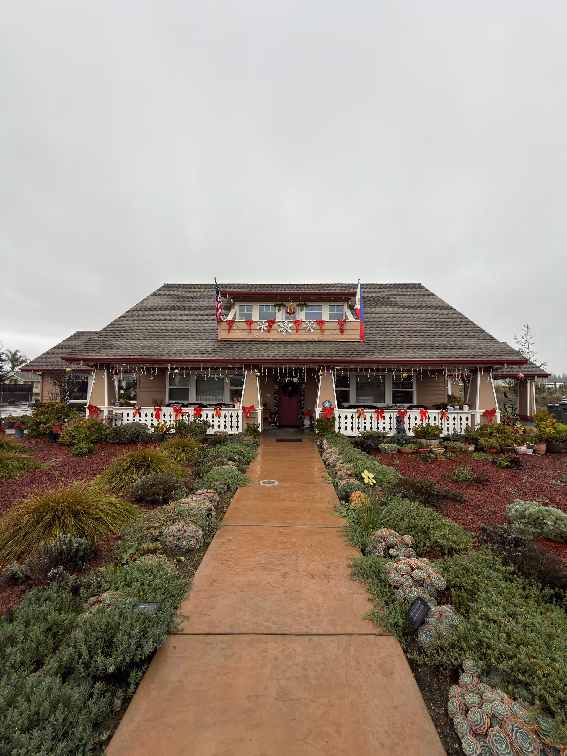 Front view of Penngrove Gardens senior living building with garden and pathway
