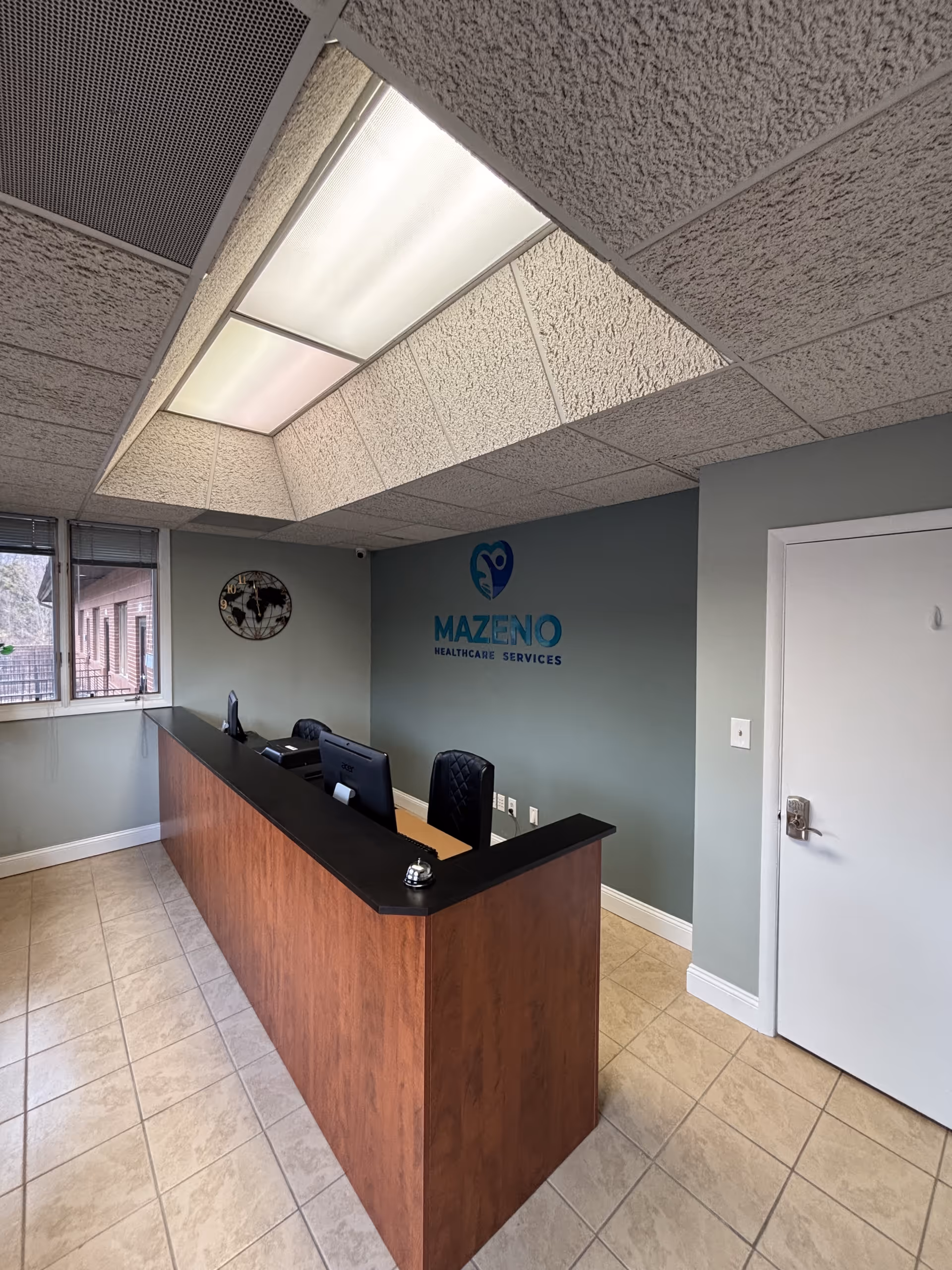 Reception desk with computers in a Mazeno Healthcare Services lobby