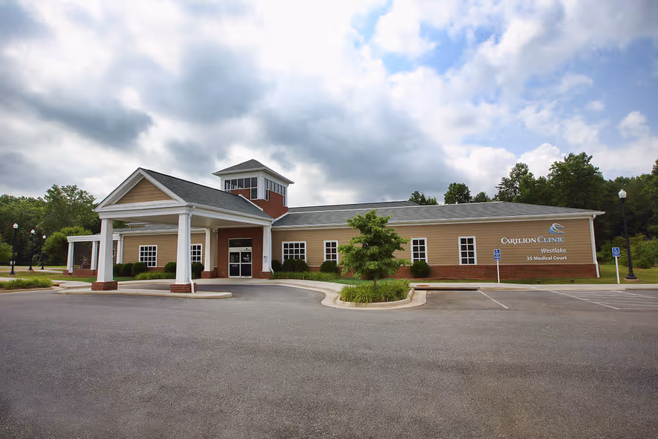 Exterior view of Carilion Clinic Home Care Bedford building with a porte-cochere entry and parking.