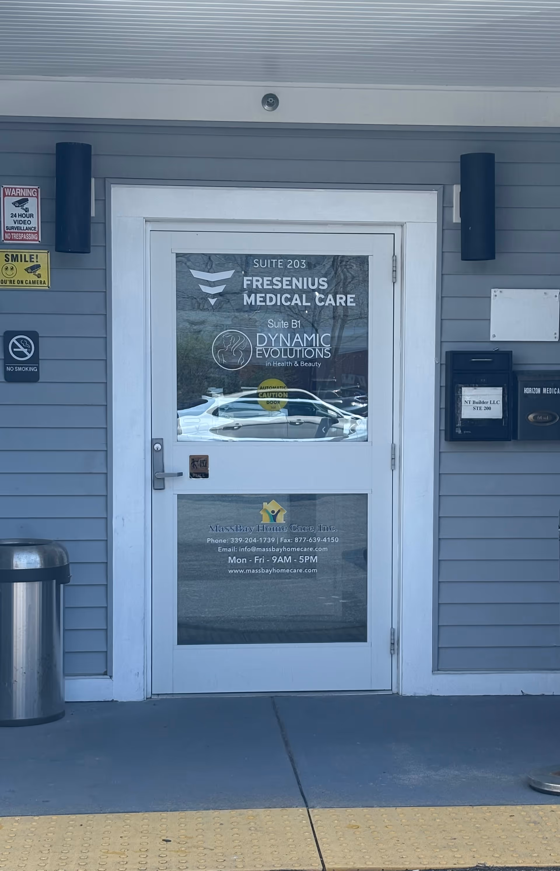 Front entrance door at MassBay Home Care, Inc. with signage and logos.