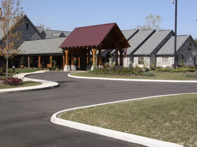 Exterior view of The Inn at CoalRidge showing stone walls and a red-roofed entrance canopy.