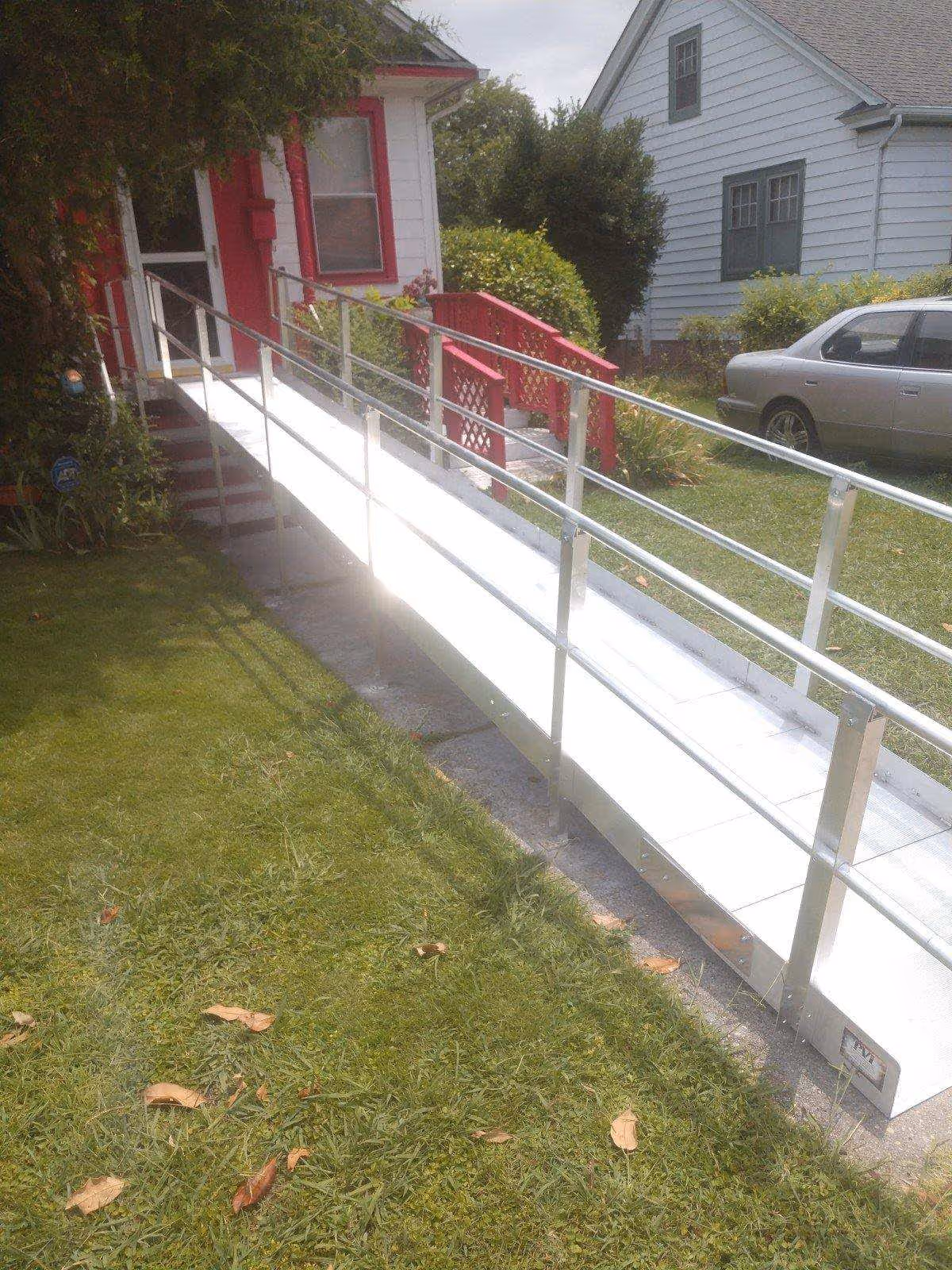 Exterior view of a wheelchair-accessible ramp leading to a house.