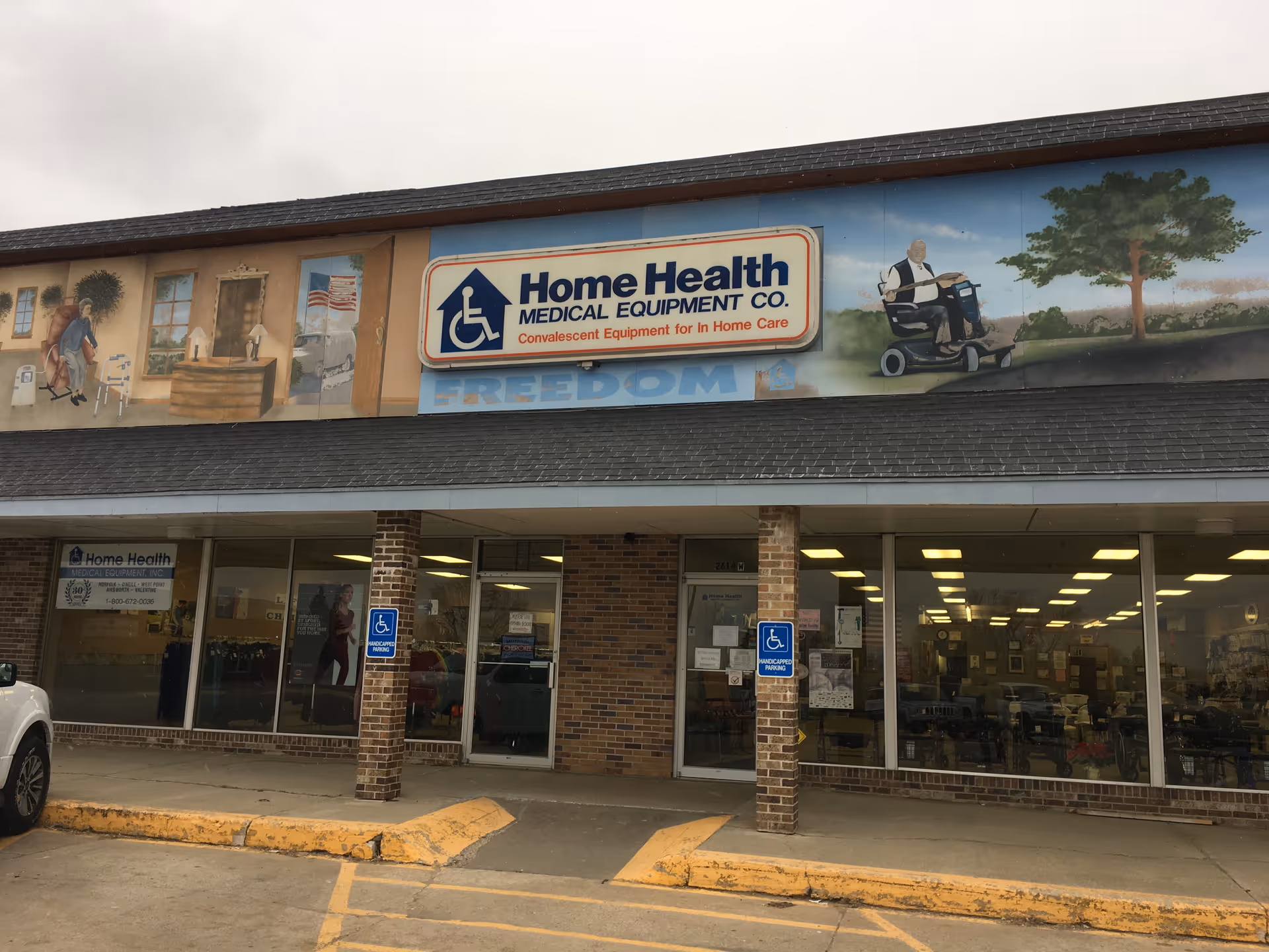 The storefront of Home Health Medical Equipment Co. with signage and glass windows.